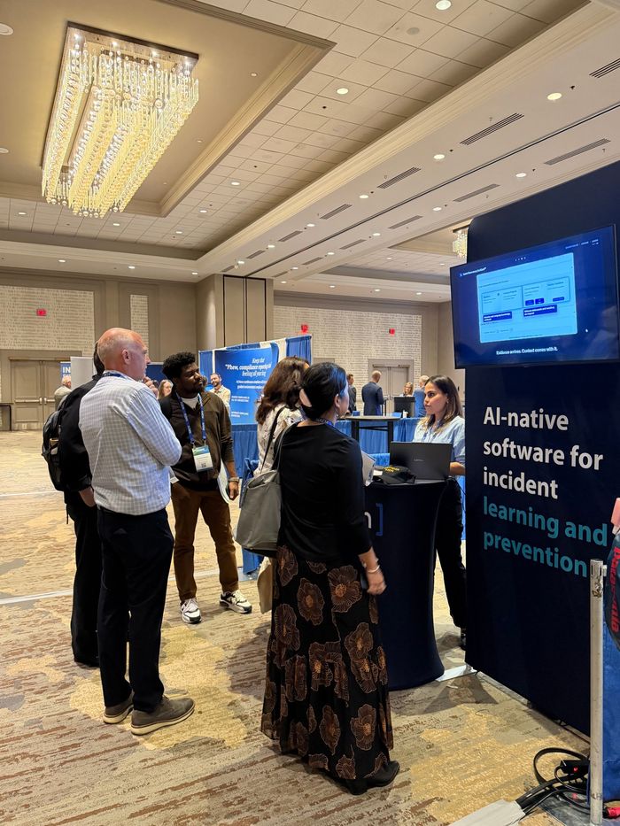 Visitors gathered around the Haven booth talking with a team member