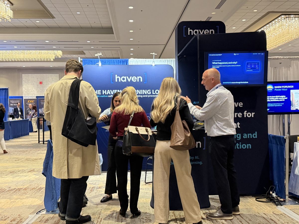 A Haven team member talking with visitors at the booth